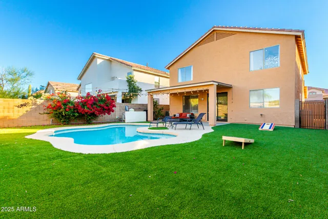 a view of a house with swimming pool yard and outdoor seating