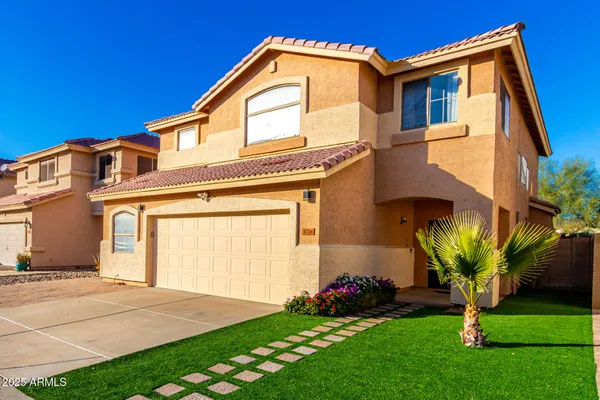 a front view of a house with a garden and plants