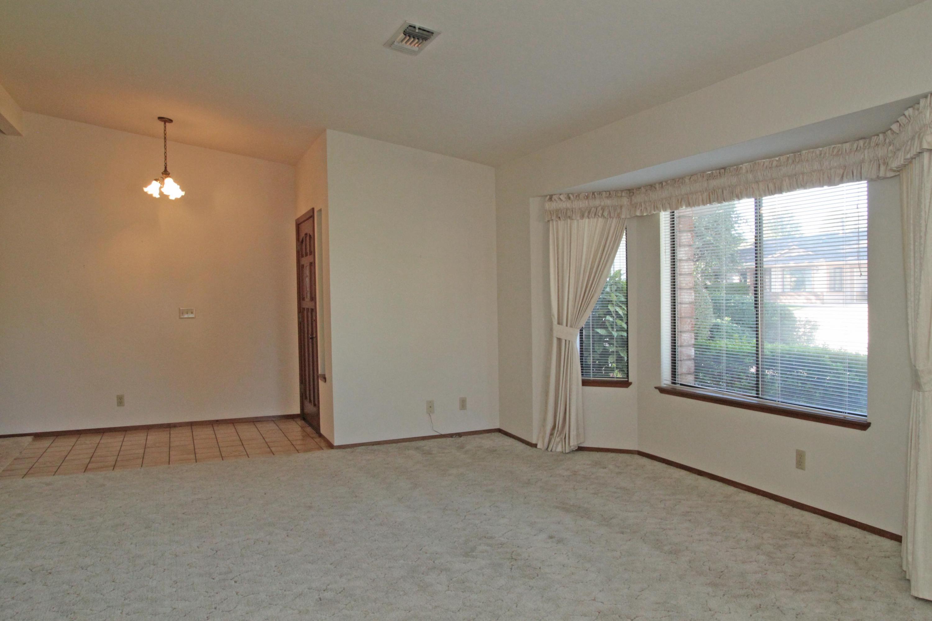 5589 Trish Court Redding, CA 96003 - Photo 5 of 20 an empty room with windows and view