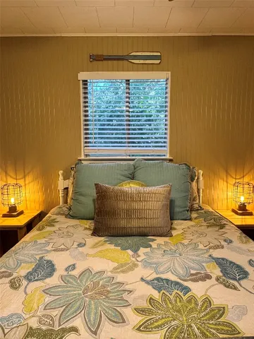 a bedroom with a bed and a chair