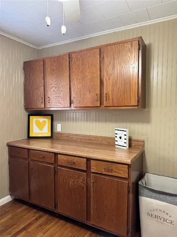 a kitchen with stainless steel appliances granite countertop wooden cabinets a sink and dishwasher with wooden floor