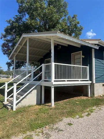a view of balcony with wooden floor and fence