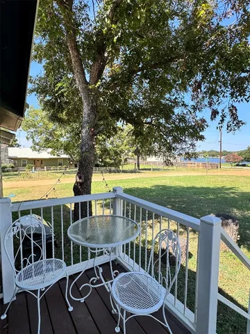 a view of a chairs and table in patio with a lake view