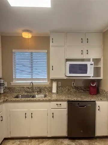 a kitchen with stainless steel appliances granite countertop a sink and a granite counter tops