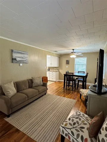 a living room with furniture and wooden floor