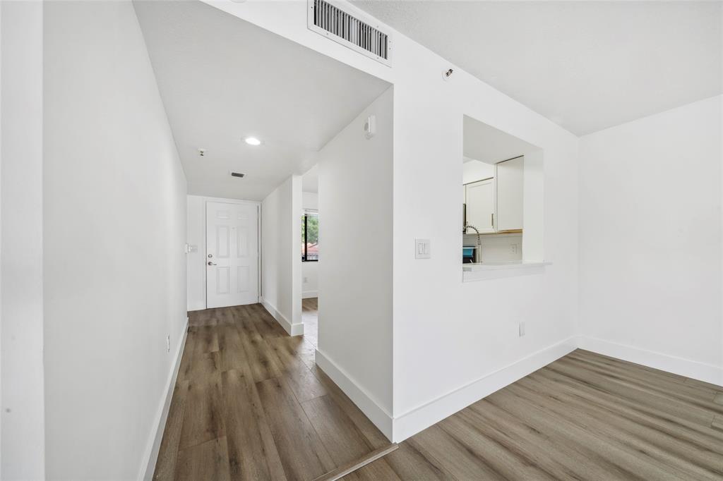6269 Pointe Regal Circle, Unit 210 Delray Beach, FL 33484 - Photo 12 of 29 wooden floor in an empty room with a window