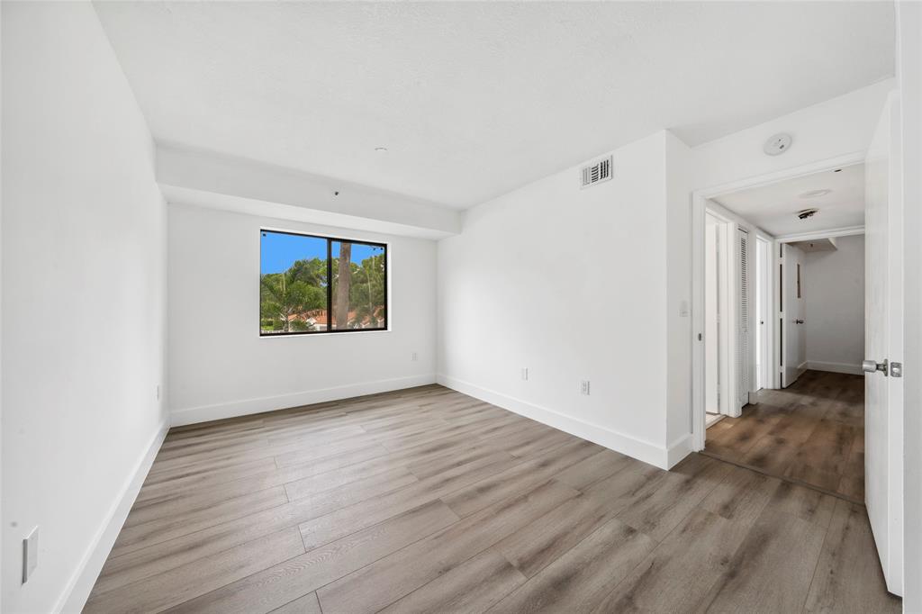 6269 Pointe Regal Circle, Unit 210 Delray Beach, FL 33484 - Photo 17 of 29 wooden floor in an empty room