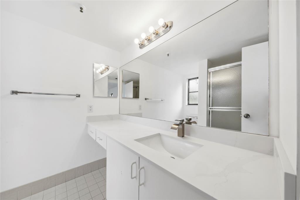 6269 Pointe Regal Circle, Unit 210 Delray Beach, FL 33484 - Photo 22 of 29 a bathroom with a sink and a mirror