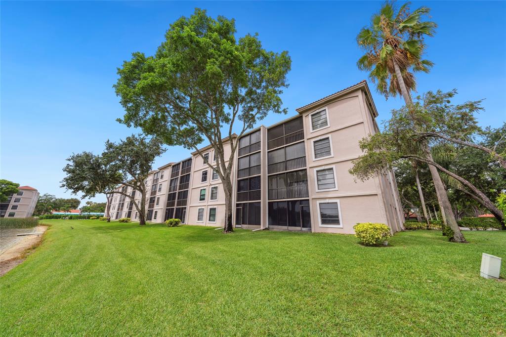 6269 Pointe Regal Circle, Unit 210 Delray Beach, FL 33484 - Photo 28 of 29 a view of a building with a yard