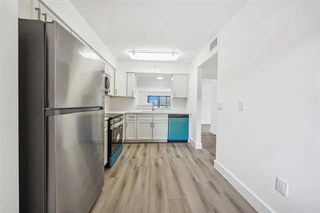 a kitchen with a refrigerator a sink and dishwasher