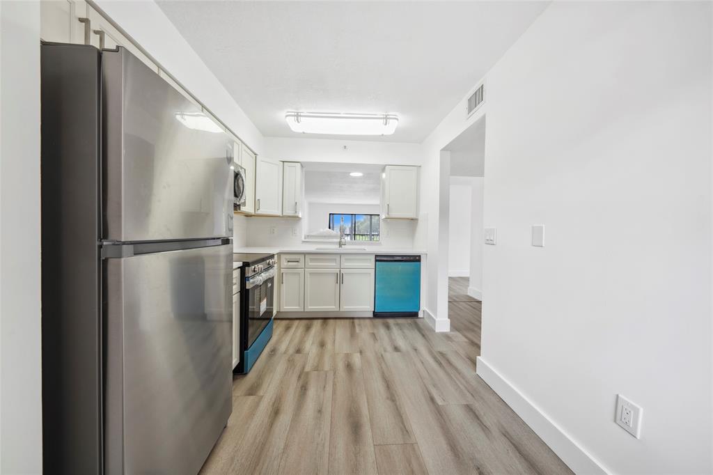 6269 Pointe Regal Circle, Unit 210 Delray Beach, FL 33484 - Photo 29 of 29 a kitchen with a refrigerator a sink and dishwasher