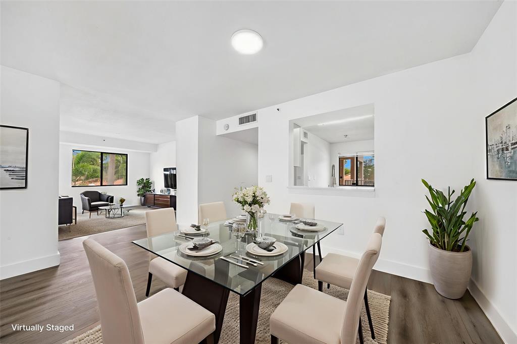 6269 Pointe Regal Circle, Unit 210 Delray Beach, FL 33484 - Photo 9 of 29 a view of a dining room with furniture window and wooden floor