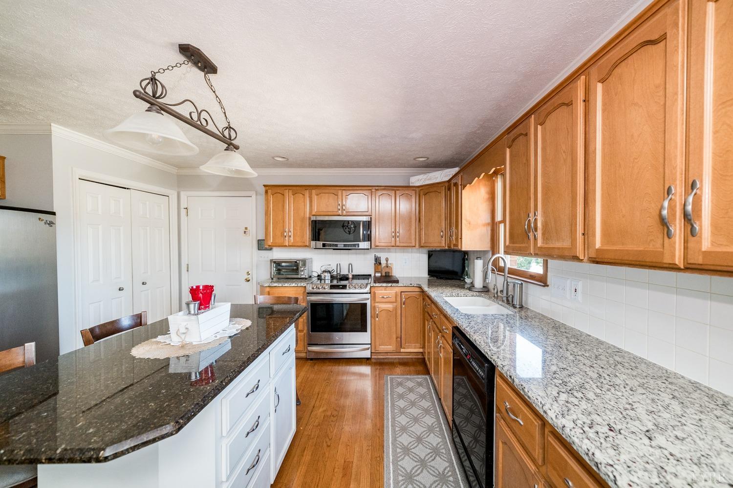 325 Longhill Road Goode, VA 24556 - Photo 23 of 71 a kitchen with stainless steel appliances granite countertop a sink stove and refrigerator