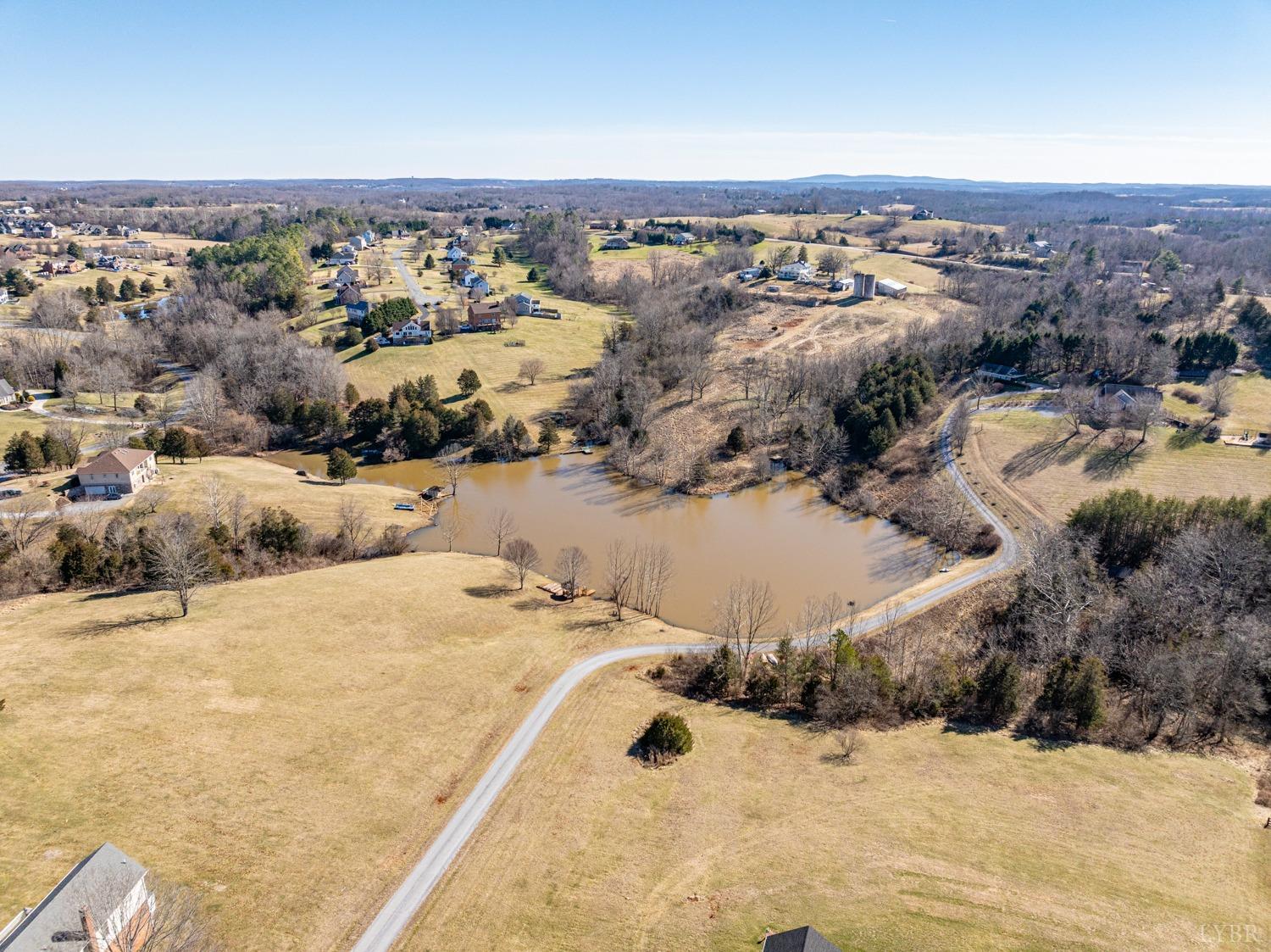 325 Longhill Road Goode, VA 24556 - Photo 8 of 71 an aerial view of a house with a yard and mountain view in back