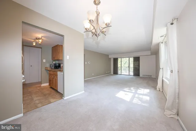 a view of a kitchen with a sink and a chandelier fan