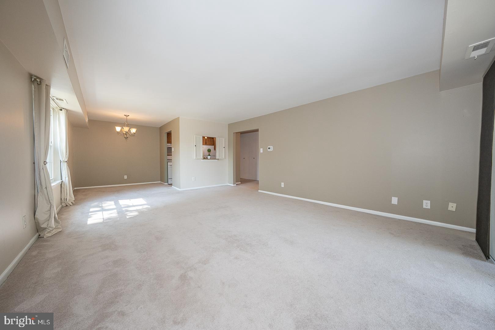 103 Drummers Lane Wayne, PA 19087 - Photo 3 of 24 an empty room with windows and entrance to other room