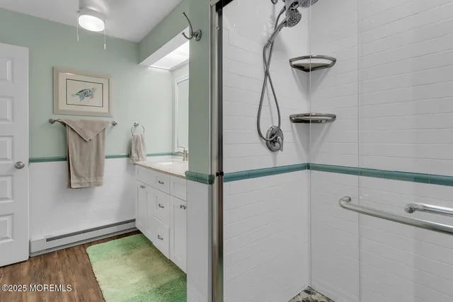 a bathroom with a shower and mirror