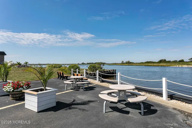 a terrace with outdoor seating and water view