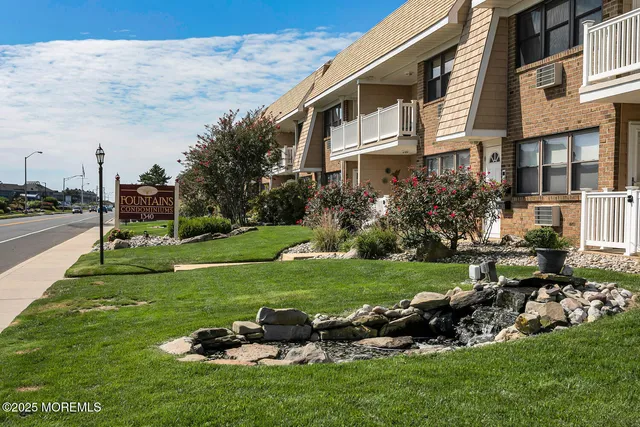 a view of a house with a yard and sitting area