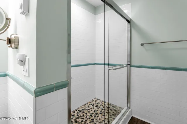 a bathroom with a shower and a sink