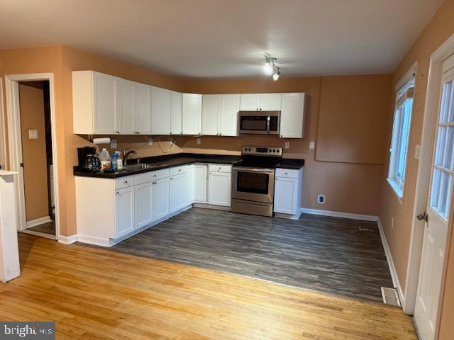 8629 Indian Springs Road Frederick, MD 21702 - Photo 4 of 9 a kitchen with stainless steel appliances granite countertop a stove a sink and a refrigerator