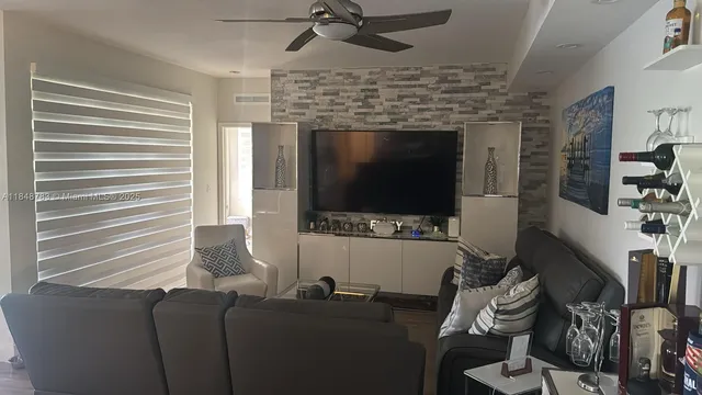 a view of a dining room with a table and chairs
