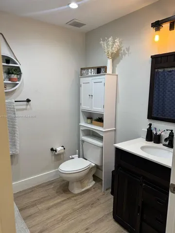 a view of a hallway view with wooden floor and staircase