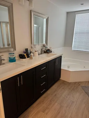 a spacious bathroom with a bathtub and a sink