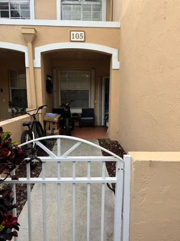 a kitchen with stainless steel appliances a sink a stove top oven a refrigerator and white cabinets