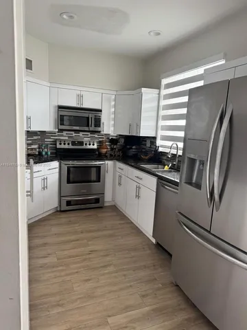 a living room with a couch and a potted plant