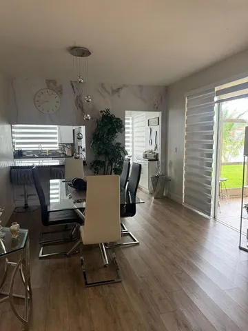 a living room with furniture window and wooden floor