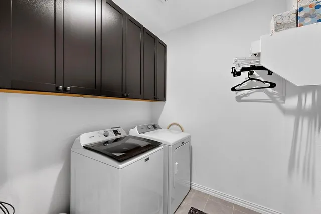 a kitchen with a sink a stove and chairs