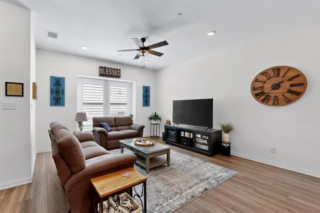 a living room with furniture and kitchen view