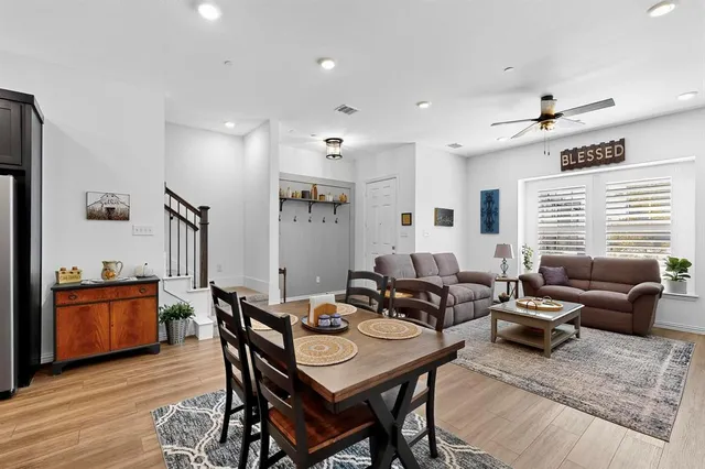 a kitchen with a dining table chairs refrigerator and cabinets
