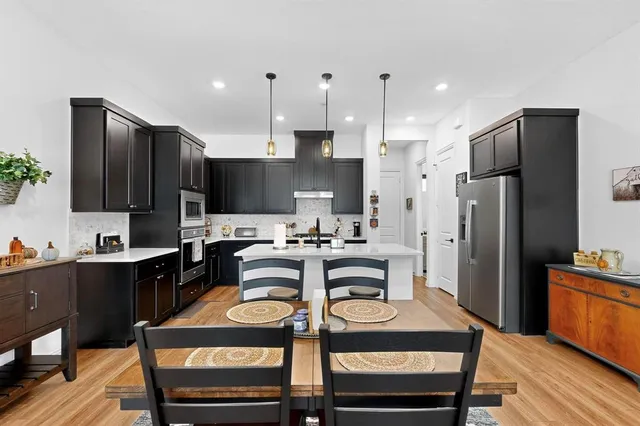 a kitchen with granite countertop a sink appliances and cabinets