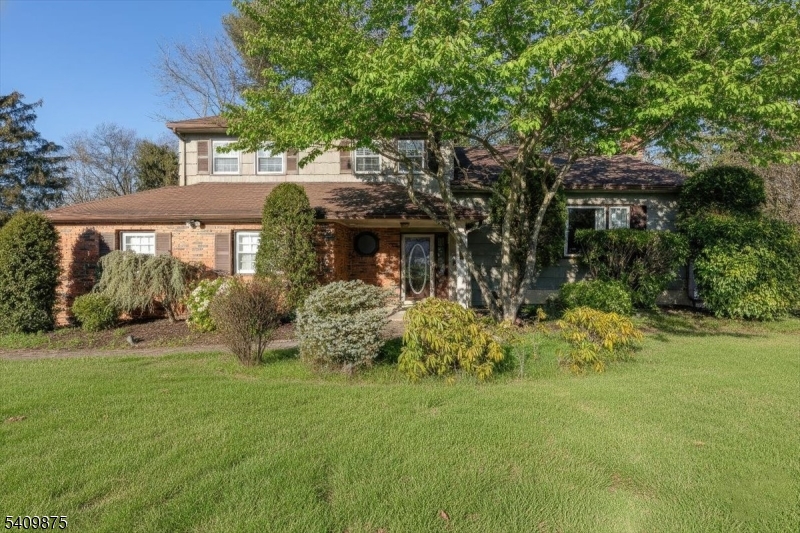 a front view of house with a garden