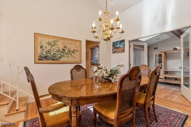 a view of a dining room with furniture and chandelier