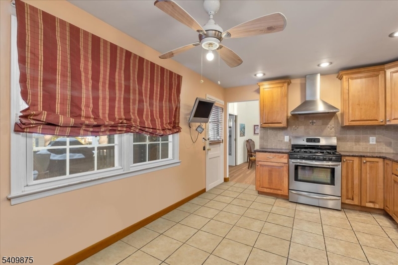 29 Manitou Circle Westfield, NJ 07090 - Photo 16 of 35 a kitchen with stainless steel appliances granite countertop a stove a sink and a microwave