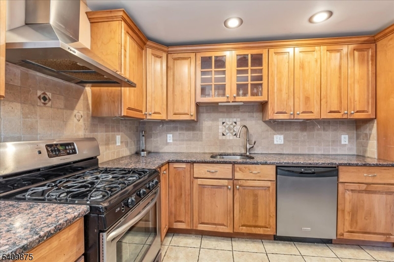 29 Manitou Circle Westfield, NJ 07090 - Photo 17 of 35 a kitchen with granite countertop a stove sink and cabinets