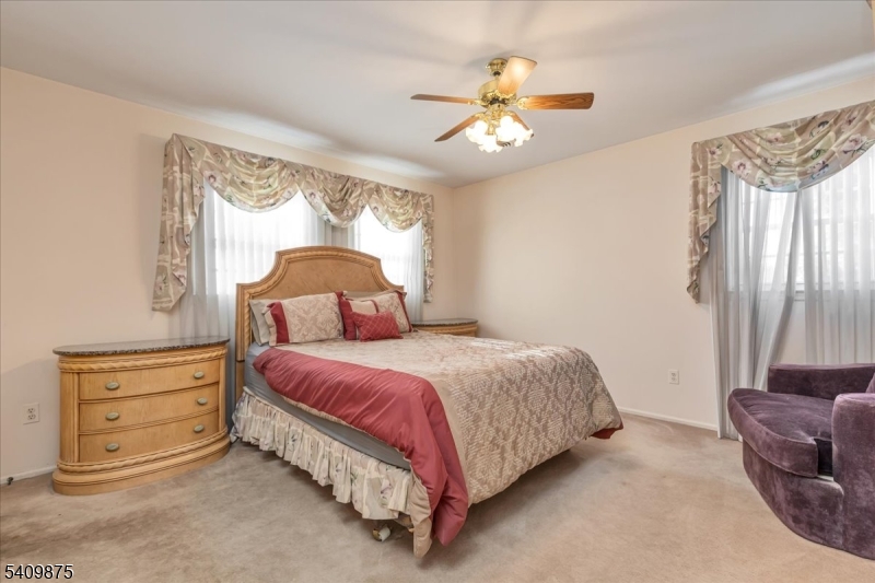 29 Manitou Circle Westfield, NJ 07090 - Photo 23 of 35 a spacious bedroom with a bed and a chandelier