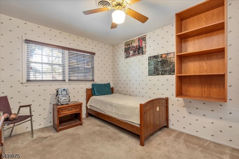 29 Manitou Circle Westfield, NJ 07090 - Photo 28 of 35 a bedroom with a bed and a chandelier