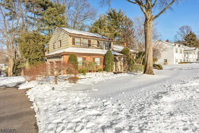 a view of a house with a snow on the road