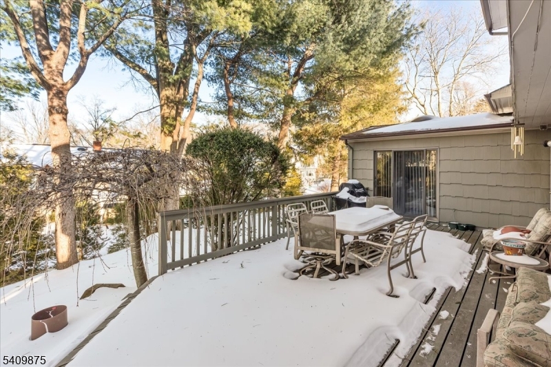 29 Manitou Circle Westfield, NJ 07090 - Photo 33 of 35 a view of a patio with table and chairs with wooden fence and large trees