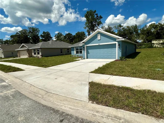 a front view of a house with a yard and garage
