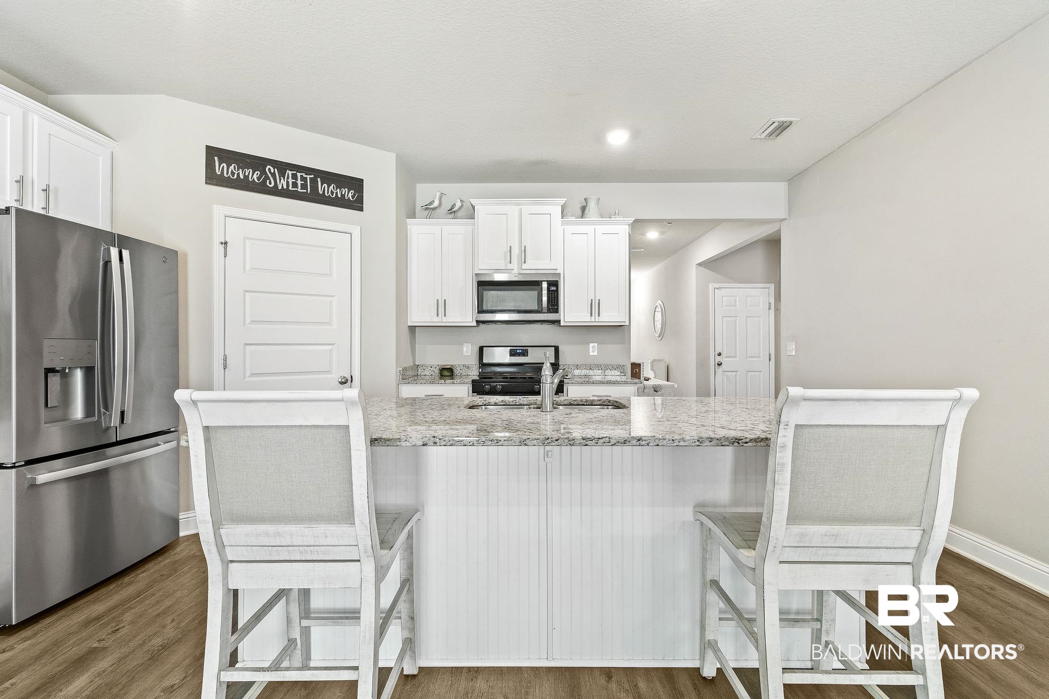 31610 Memphis Loop Daphne, AL 36527 - Photo 10 of 67 Kitchen with a sink, stainless steel appliances, dark wood-type flooring, and white cabinetry