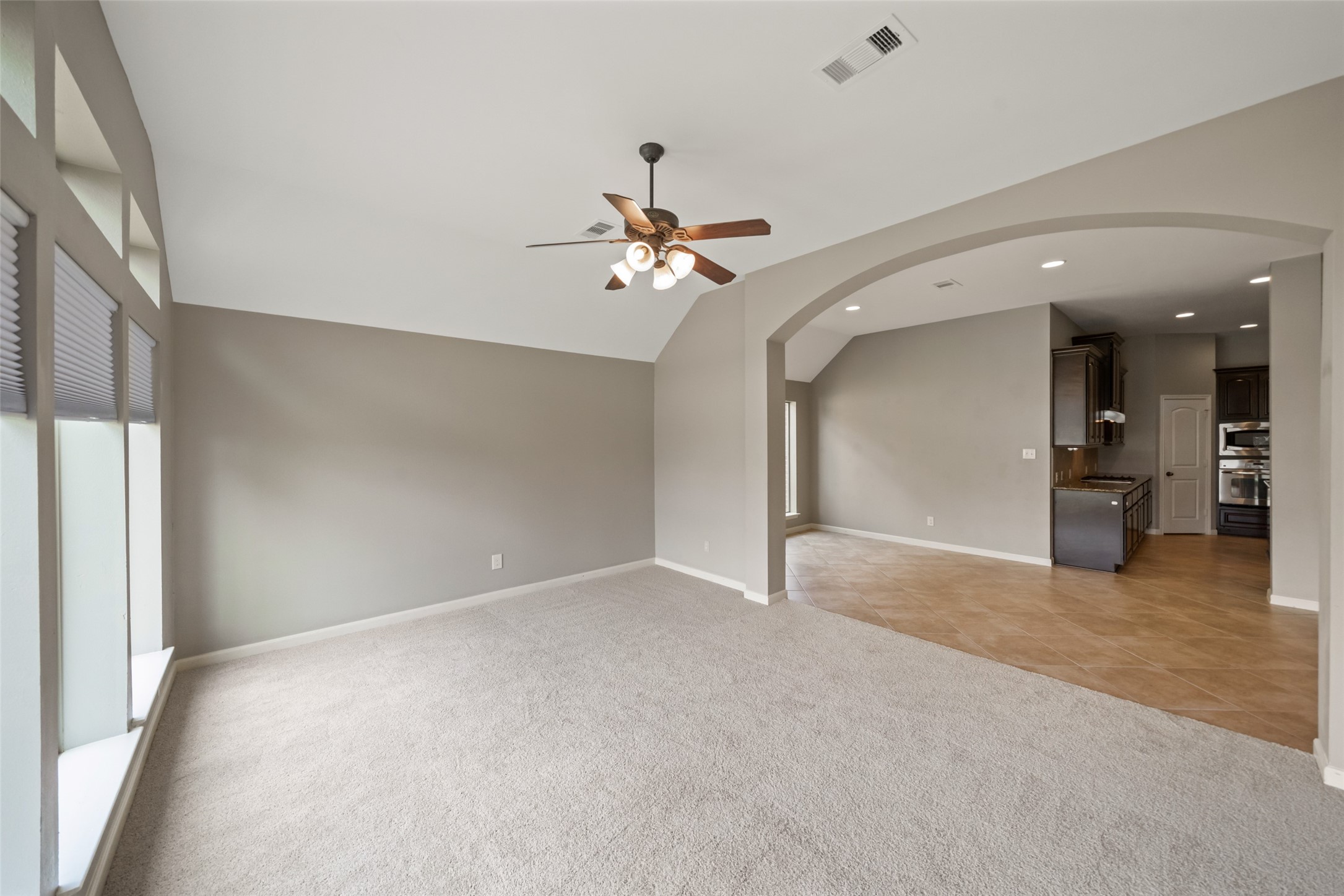 2818 Red Maple Drive Katy, TX 77494 - Photo 31 of 50 an empty room with fan and way to kitchen
