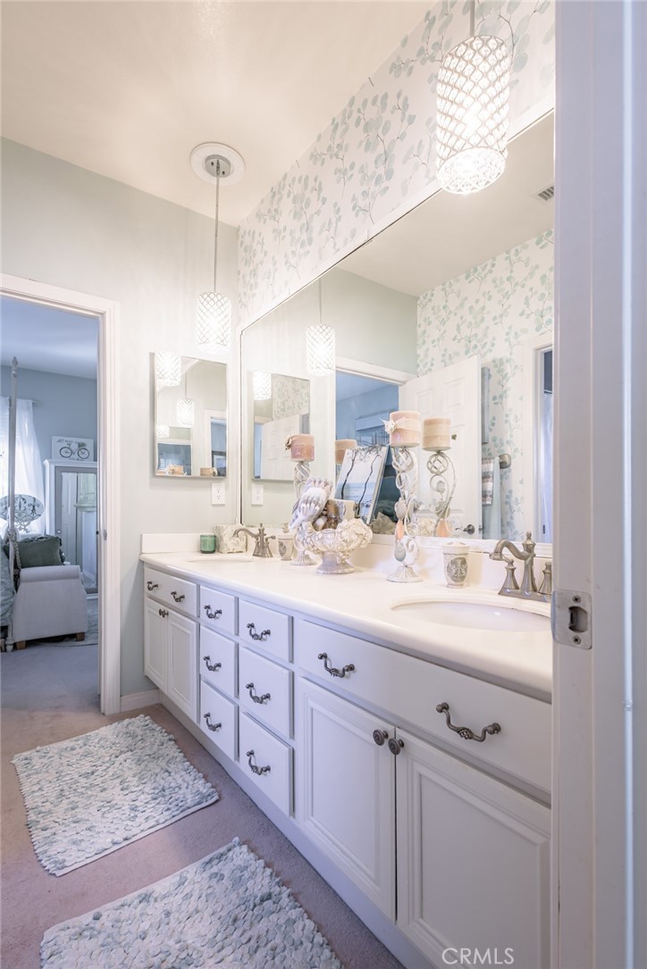 1045 Inverlochy Drive Fallbrook, CA 92028 - Photo 22 of 39 a spacious bathroom with double sink and a large mirror