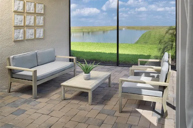 a living room with furniture and a floor to ceiling window