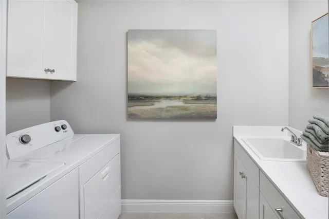 a room with a sink and cabinets