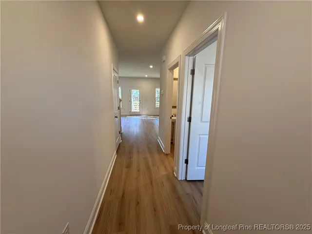 a view of a hallway with wooden floor